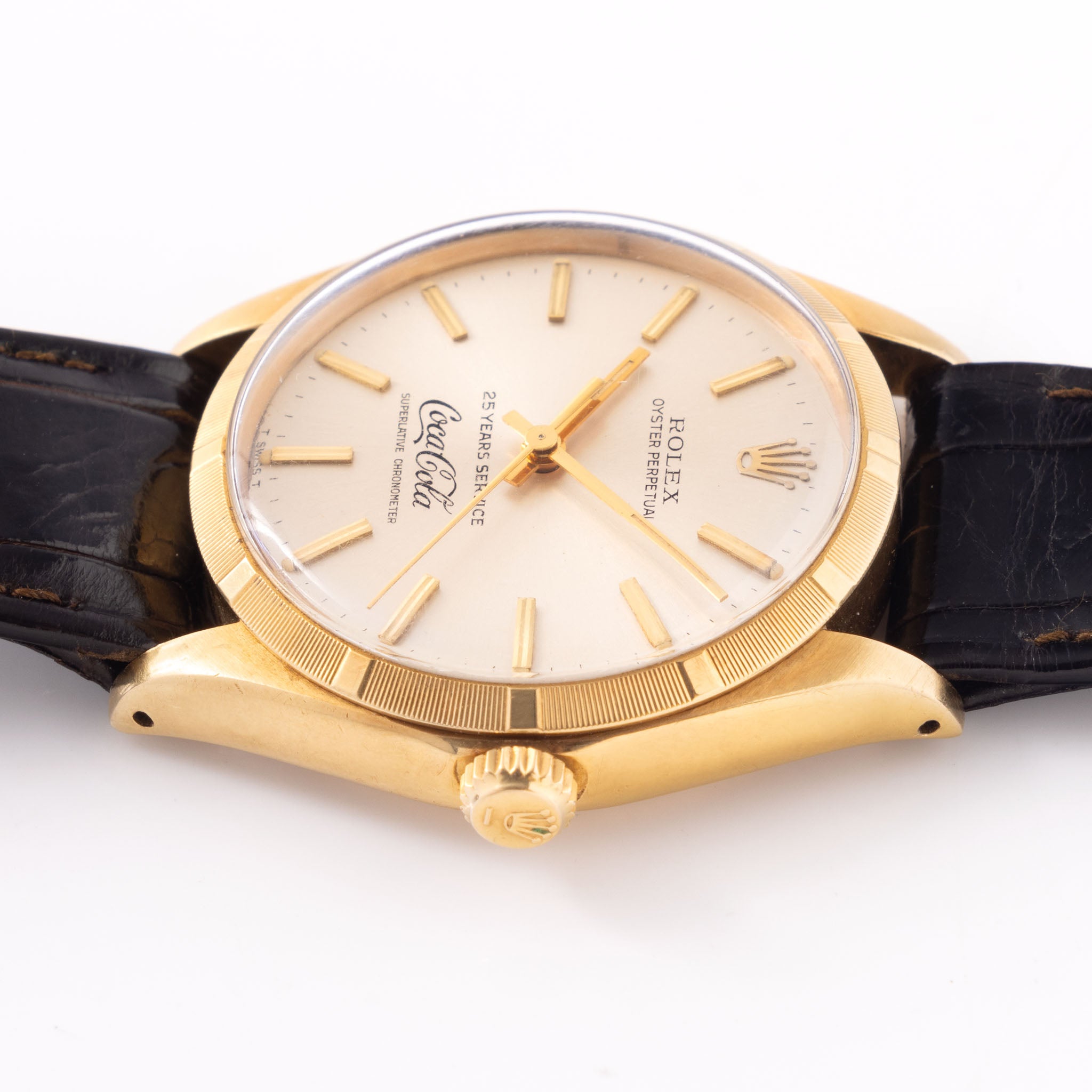 Rolex Oyster -Perpetual silver "25 years Coca Cola service " logo dial in 18 k yellow gold with original double punched papers ref 1003